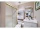 Bathroom featuring a walk-in shower and white vanity with a small sink at 10873 W 84Th Pl, Arvada, CO 80005