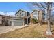 A well-maintained two-story home with attached garage and charming front yard at 10873 W 84Th Pl, Arvada, CO 80005