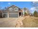 Charming two-story home with stone walkway and attached three-car garage at 10873 W 84Th Pl, Arvada, CO 80005