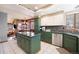 Well-lit kitchen featuring modern appliances, a center island with a cooktop, and a view of the dining area at 10873 W 84Th Pl, Arvada, CO 80005