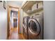 Laundry room with side-by-side washer and dryer, providing convenience and functionality at 10873 W 84Th Pl, Arvada, CO 80005