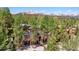 Aerial view of a beautiful mountain home surrounded by lush trees and snow-capped mountains at 434 Kings Crown Rd, Breckenridge, CO 80424