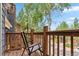 This cozy balcony overlooks a walkway and a lovely landscape of trees and lush greenery at 434 Kings Crown Rd, Breckenridge, CO 80424