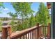 Balcony with wooden railing offers views of lush trees and neighborhood rooftops at 434 Kings Crown Rd, Breckenridge, CO 80424