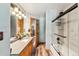 Modern bathroom featuring wood cabinets, a gray countertop and a glass enclosed shower and tub at 434 Kings Crown Rd, Breckenridge, CO 80424