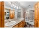 Bathroom with double sink vanity, wood cabinets, and shower with sliding glass door at 434 Kings Crown Rd, Breckenridge, CO 80424