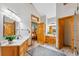 Bathroom featuring double sinks, wooden cabinets, wood flooring, and natural light at 434 Kings Crown Rd, Breckenridge, CO 80424