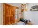 Foyer entrance featuring a wooden door, decorative rug, bench, and charming wall decor at 434 Kings Crown Rd, Breckenridge, CO 80424