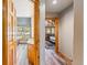Hallway view through wooden doorframes leading to rooms with wood floors and natural light at 434 Kings Crown Rd, Breckenridge, CO 80424