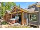 Covered hot tub area on deck with privacy fencing, surrounded by lush greenery at 434 Kings Crown Rd, Breckenridge, CO 80424