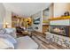 Comfortable living room with stone fireplace and view to kitchen and dining at 434 Kings Crown Rd, Breckenridge, CO 80424