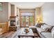 Cozy living room with stone fireplace and large windows overlooking the outdoors at 434 Kings Crown Rd, Breckenridge, CO 80424