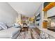 Open living space with wood floors, stone fireplace, and a view to the kitchen at 434 Kings Crown Rd, Breckenridge, CO 80424