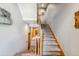 Carpeted staircase with wooden railing, leading to a well-lit upper level of the home at 434 Kings Crown Rd, Breckenridge, CO 80424