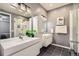 Modern bathroom with dual sinks, sleek white cabinetry, and a glass-enclosed shower, offering a spa-like experience at 2100 N Humboldt St # 207, Denver, CO 80205