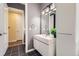 Bathroom features a modern sink, black tile floors, modern vanity, and access to the rest of the house at 2100 N Humboldt St # 207, Denver, CO 80205