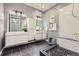 This bathroom features double sinks, modern shower, black tile floors, and clean white cabinetry at 2100 N Humboldt St # 207, Denver, CO 80205