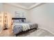Comfortable bedroom with neutral tones, cozy carpet, and minimalist decor at 2100 N Humboldt St # 207, Denver, CO 80205