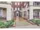 Exterior view of an open gate leading to a courtyard with manicured landscaping and building entrance at 2100 N Humboldt St # 207, Denver, CO 80205