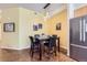 Cozy dining area features a modern light fixture, artwork, and seating for four at 2100 N Humboldt St # 207, Denver, CO 80205