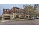 Apartment building featuring a brick facade, balconies, and underground parking at 2100 N Humboldt St # 207, Denver, CO 80205