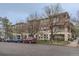 Multi-unit building showcasing brick and stone accents, balconies, and mature trees in a residential neighborhood at 2100 N Humboldt St # 207, Denver, CO 80205