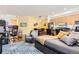 Cozy living room featuring a modern workspace, sitting area, and an open kitchen at 2100 N Humboldt St # 207, Denver, CO 80205