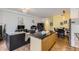 Stylish open-concept living space with a kitchen island, dining area, and comfortable living room at 2100 N Humboldt St # 207, Denver, CO 80205