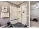 This bathroom has a walk-in shower that features black pebble flooring and white tile walls at 2100 N Humboldt St # 207, Denver, CO 80205