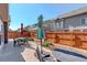 Patio space with dark metal furniture, lawn, and grill at 10777 Wheeling Dr, Commerce City, CO 80022