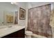 Bathroom featuring a vanity sink, toilet, and shower with patterned curtain at 10777 Wheeling Dr, Commerce City, CO 80022