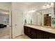 Bathroom boasts double sinks, a large mirror, and access to the shower area at 10777 Wheeling Dr, Commerce City, CO 80022