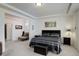 Bright bedroom showcases neutral colors, a tray ceiling, and ample space at 10777 Wheeling Dr, Commerce City, CO 80022