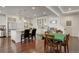 Open-concept kitchen showcasing a large island, hardwood floors, and white cabinetry with glass accents at 10777 Wheeling Dr, Commerce City, CO 80022