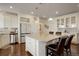 Kitchen showcases island with bar seating, stainless appliances, and bright white cabinetry at 10777 Wheeling Dr, Commerce City, CO 80022