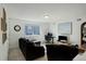 Cozy living room with a sofa, desk setup, and natural light from the window at 10777 Wheeling Dr, Commerce City, CO 80022