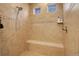 Shower features tiled walls, a built-in seat, and decorative accent tiles at 10777 Wheeling Dr, Commerce City, CO 80022