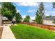 Private, fenced backyard with lush lawn, mature trees and a large patio for entertaining at 5101 E 122Nd Cir, Thornton, CO 80241