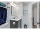 Updated bathroom features a modern vanity, updated fixtures, and convenient storage shelves at 5101 E 122Nd Cir, Thornton, CO 80241