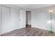 Bright bedroom features wood-look floors, a green floor lamp and white closet doors at 5101 E 122Nd Cir, Thornton, CO 80241