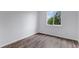 Cozy bedroom with laminate floors, a window with natural light, and white walls at 5101 E 122Nd Cir, Thornton, CO 80241