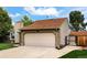 Exterior view of a two-car garage, showing the home's driveway and gated entrance at 5101 E 122Nd Cir, Thornton, CO 80241