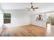 Bright living room with hardwood floors, ceiling fan, and large window showcasing natural light at 5101 E 122Nd Cir, Thornton, CO 80241