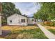 Side yard shows manicured plantings and sidewalk leading to the main home at 5147 Saint Paul St, Denver, CO 80216