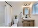 Charming bathroom with a rustic wood vanity, modern fixtures, and window at 5147 Saint Paul St, Denver, CO 80216