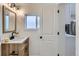 Inviting bathroom featuring a wood vanity, modern fixtures, and window at 5147 Saint Paul St, Denver, CO 80216