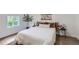 Cozy bedroom featuring a natural-toned decor, large window, and minimalist aesthetic at 5147 Saint Paul St, Denver, CO 80216
