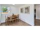 Dining room features laminate wood flooring, white walls, updated trim and large window at 5147 Saint Paul St, Denver, CO 80216