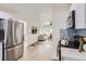 Open concept view of the kitchen flowing into the living room with modern appliances at 5147 Saint Paul St, Denver, CO 80216