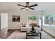 Well-lit living room with modern furnishings, sleek flooring and a view of the yard at 5147 Saint Paul St, Denver, CO 80216